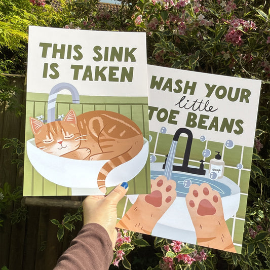Framed Wash Your Little Toe Beans print with sink, paw hands, orange and green tones