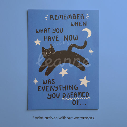 Close-up blue cat motivation wall print with black cat and handwritten quote text