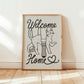 Framed Welcome Home cat lover print with two cats and heart, black line art on beige