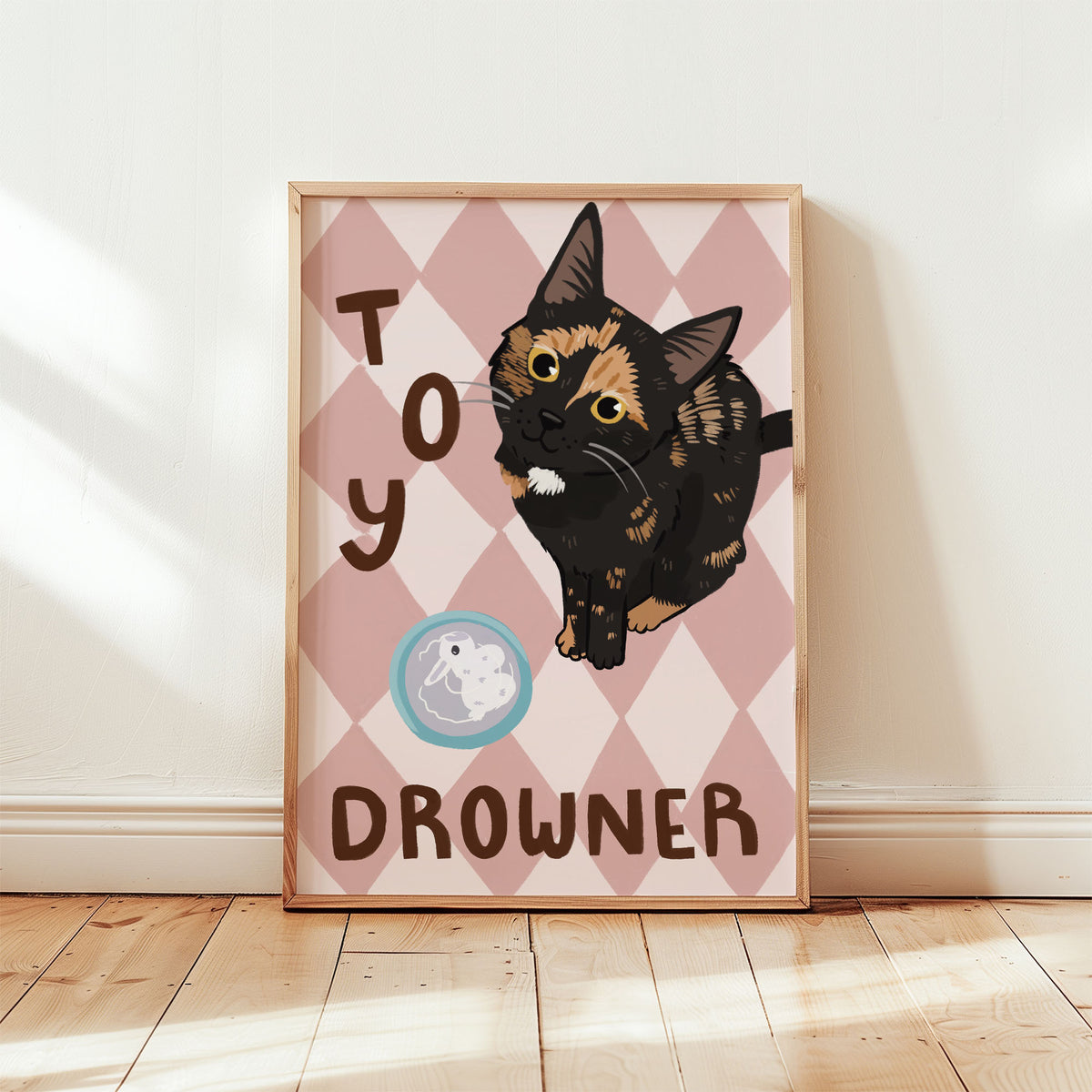 Cat print with black kitten and white muzzle on tan-pink diamonds; 'TOY' and 'DROWNER'