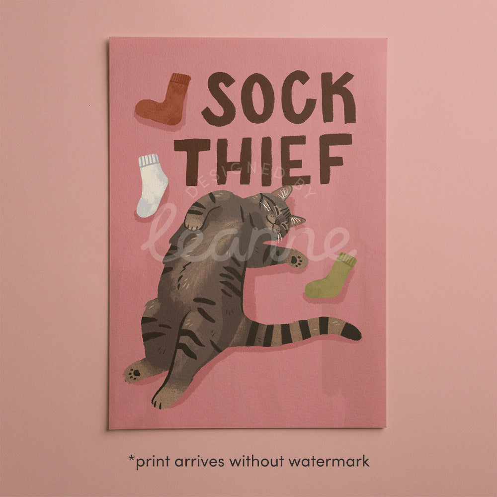 Unframed cat print: 'SOCK THIEF' text, gray cat reaching with colored sock icons