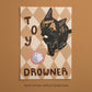 Cat print artwork with black-and-tan kitten in diamond pattern, 'TOY' and 'DROWNER' text