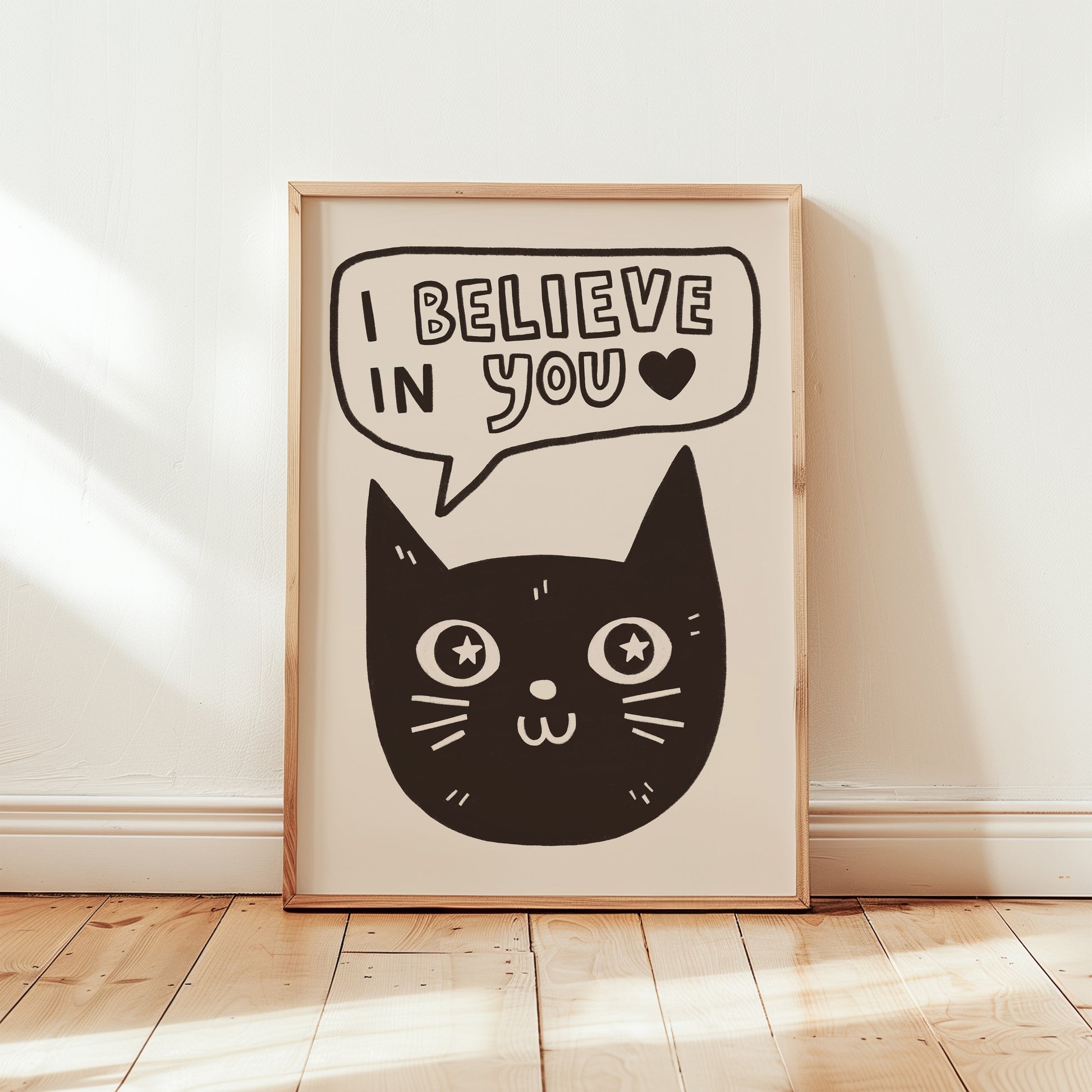 Unframed cat print wall art with black cat face, star eyes, and “I Believe in You” speech bubble
