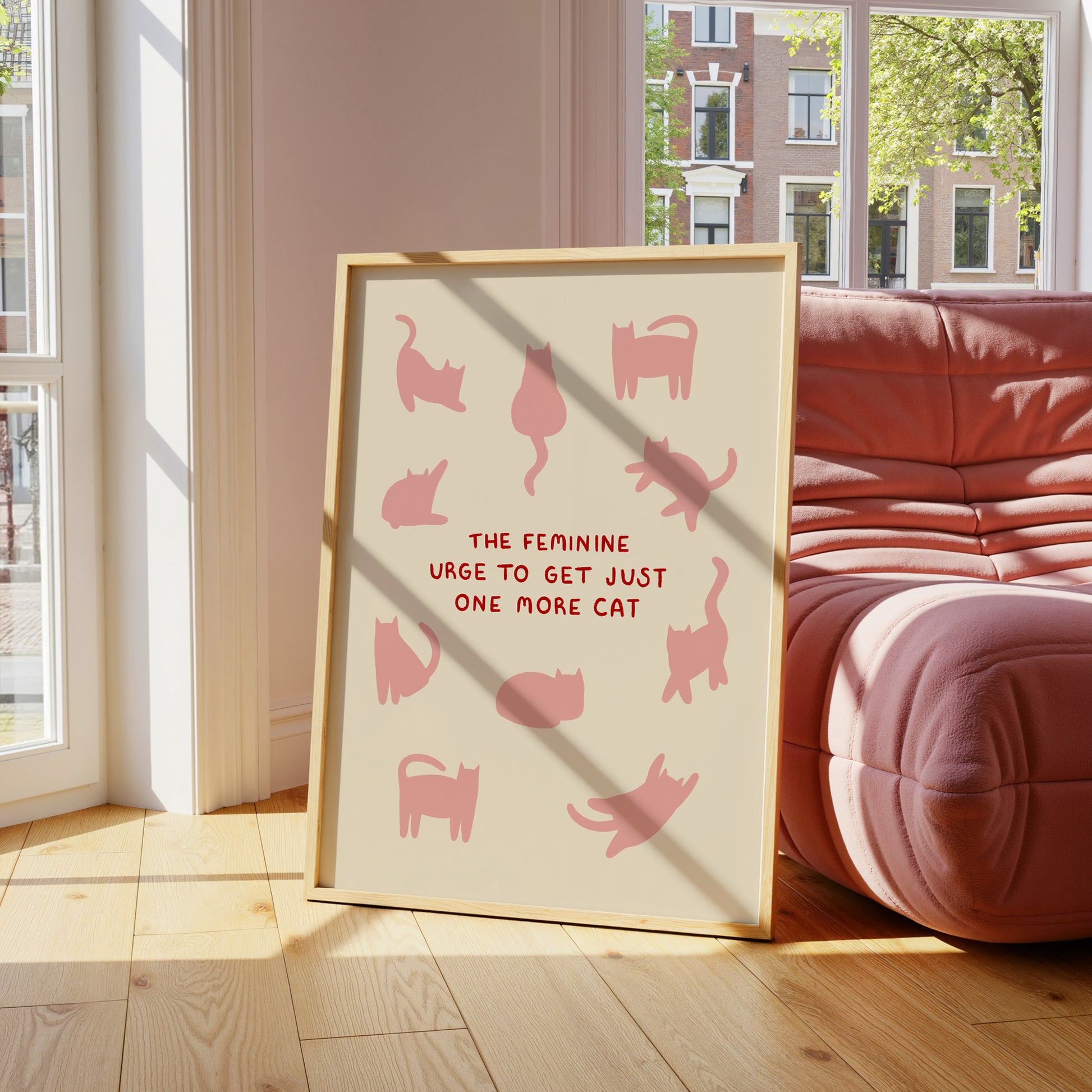 Cat quote print leaning on floor, pink cat silhouettes with red “ONE MORE CAT” text