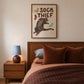 Framed cat print featuring 'SOCK THIEF' text, gray cat holding a light gray sock