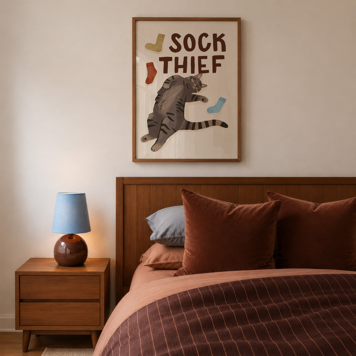 Framed cat print featuring 'SOCK THIEF' text, gray cat holding a light gray sock