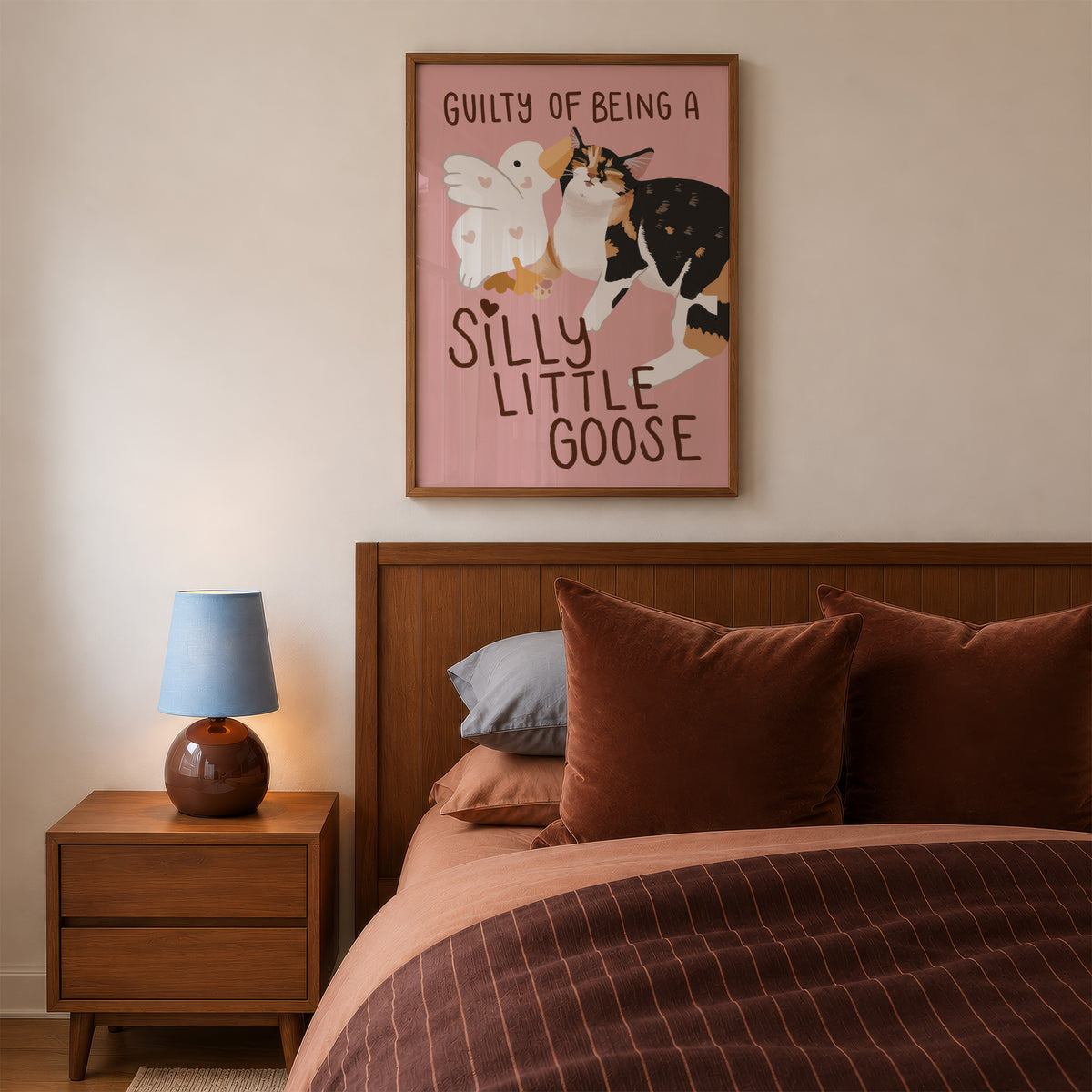 Unframed goose and cat illustration print with “Silly Little Goose” on muted pink