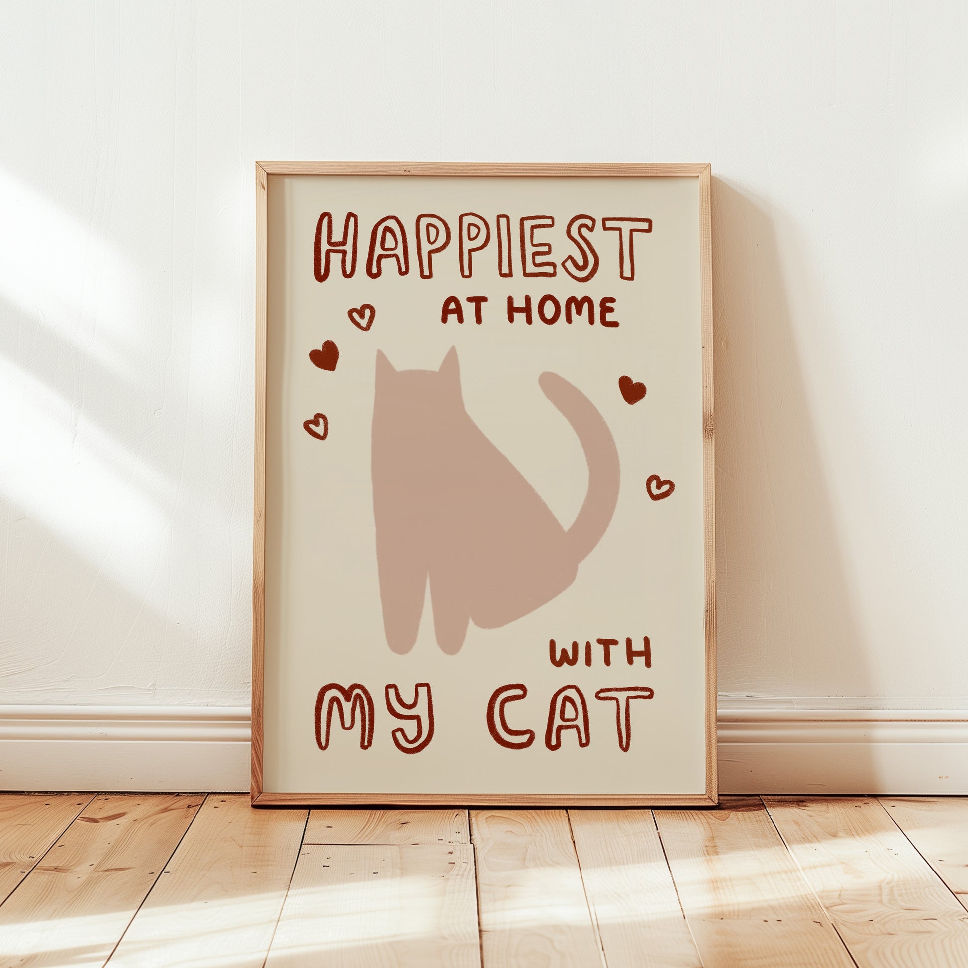 Happiest at Home print with brown cat, red hearts, “with my cat” in light wood frame