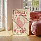 Happiest at Home print with pink cat, red lettering and hearts, “with my cat” in frame