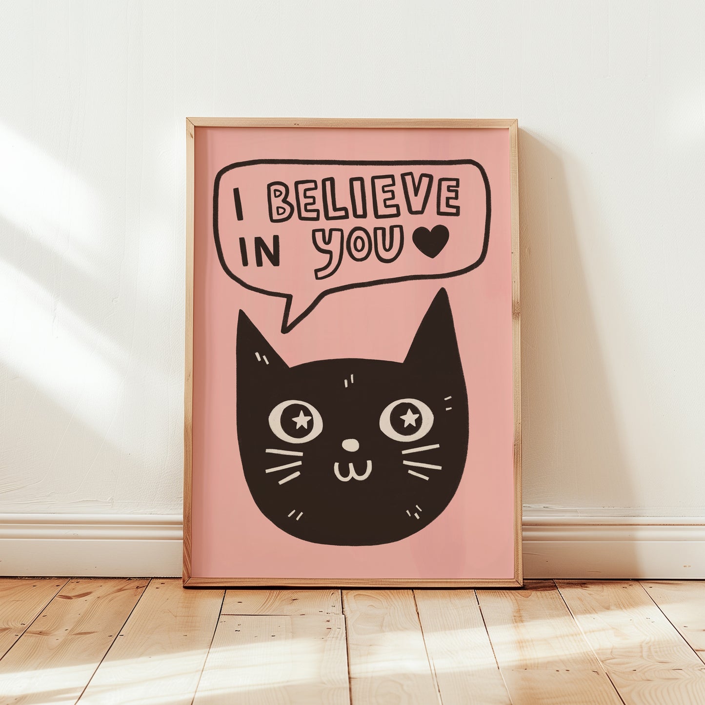 Unframed cat print wall art with black cat face and “I Believe in You” on pink background