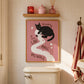 Cat toilet paper print in frame on tiled bathroom wall, pink background