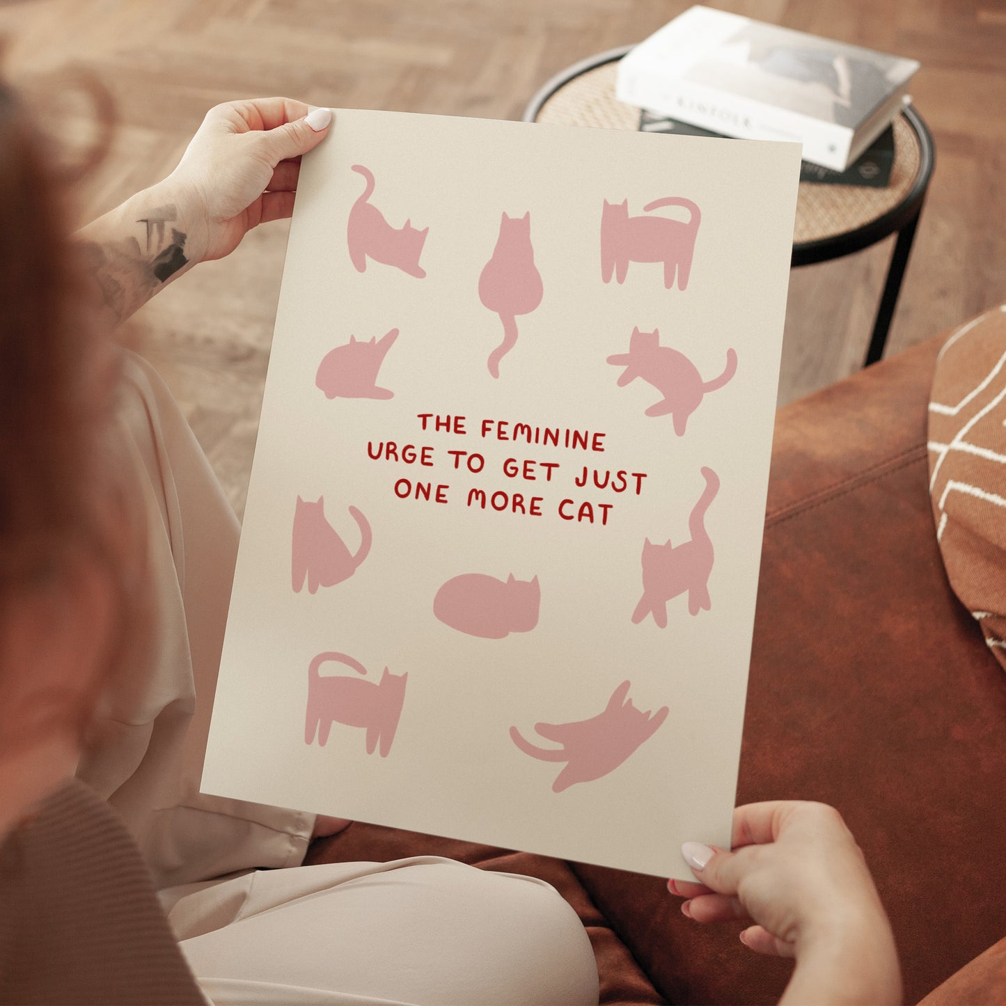 Unframed cat quote print held up, pink cats and red “THE FEMININE…ONE MORE CAT”