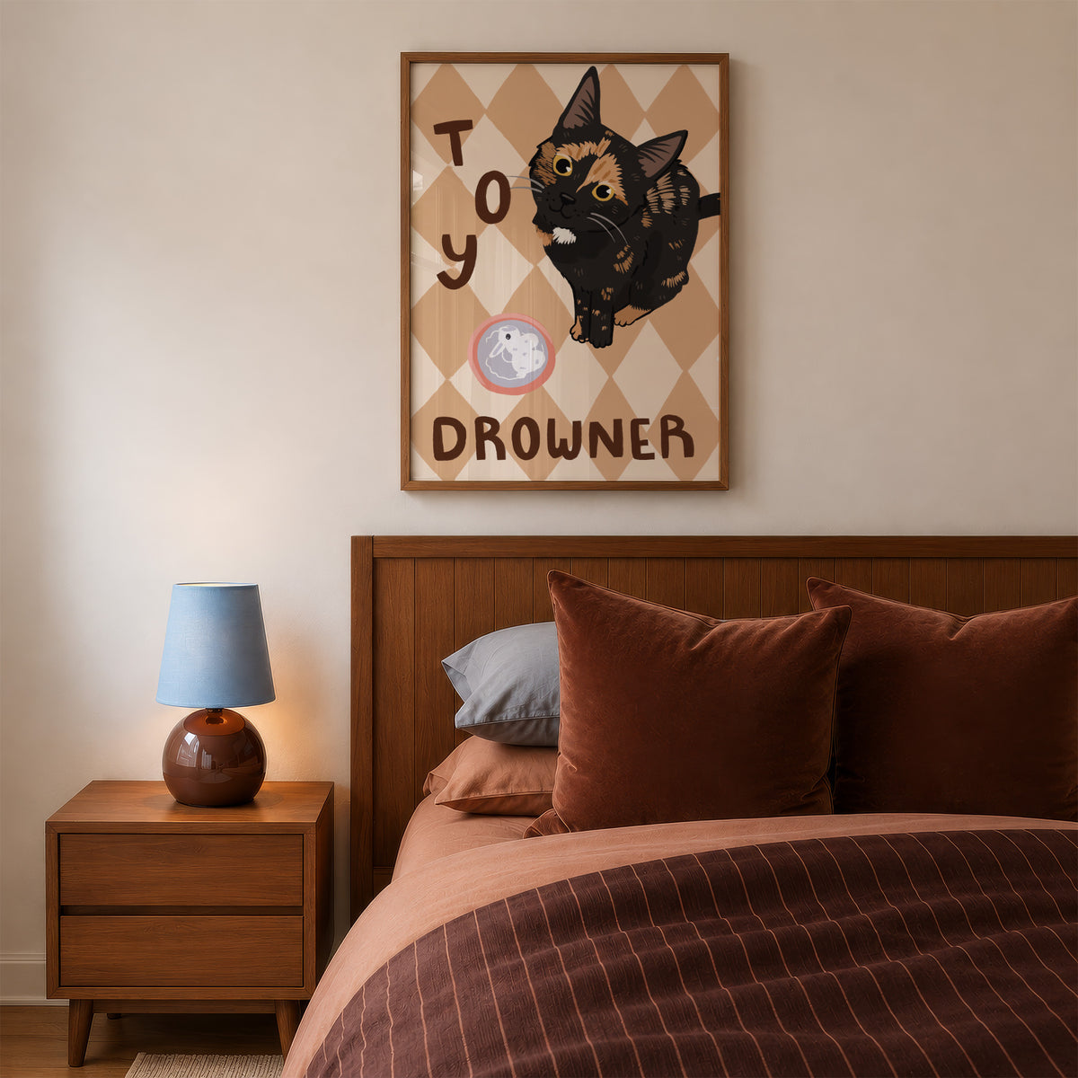 Cat print in small wall frame, black kitten illustration on tan diamond background with toy icon