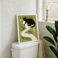 Cat toilet paper print in frame on toilet, olive green background