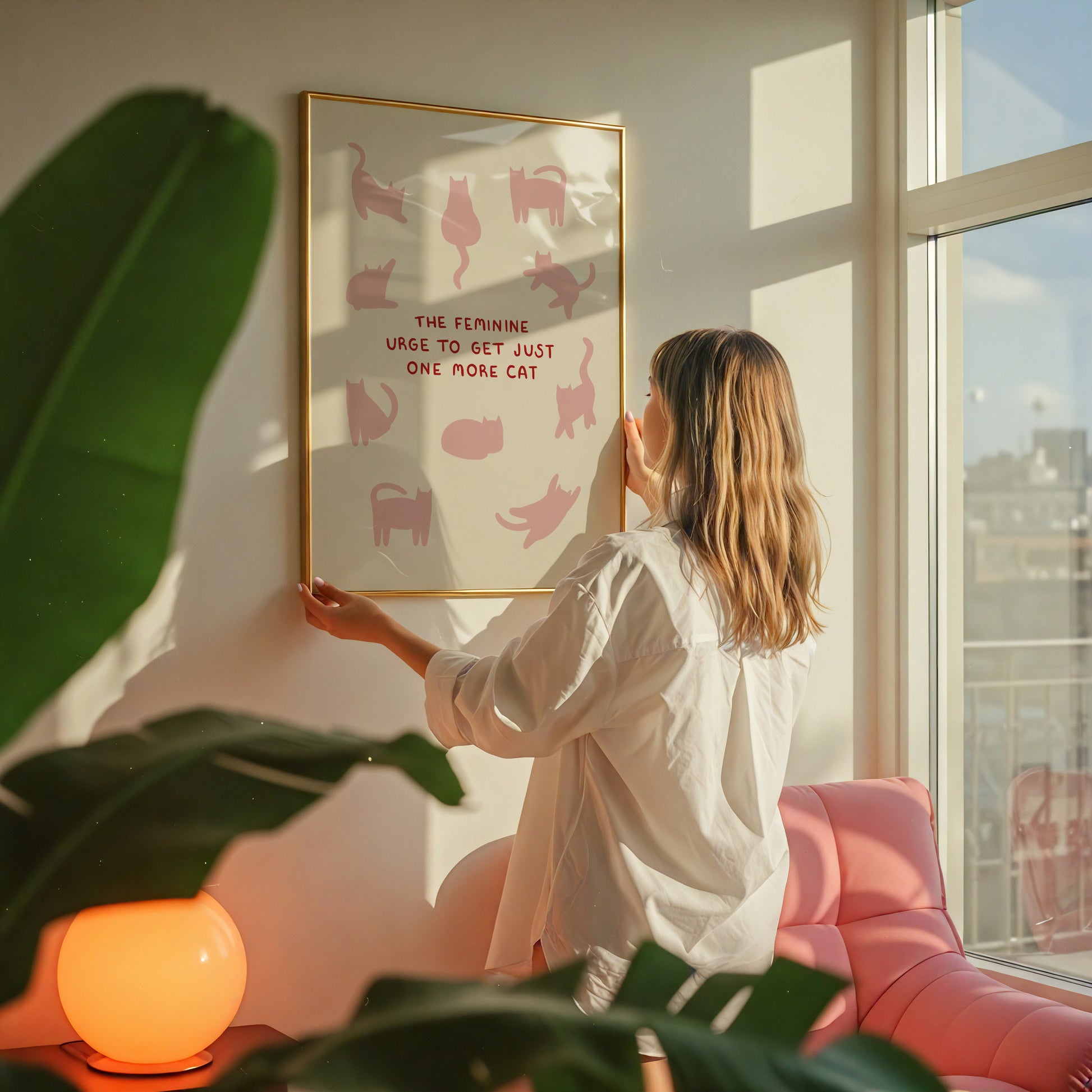 Cat quote print on wall in frame, pink cats and red “ONE MORE CAT” wording