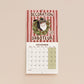 December page of cat-themed 2027 wall calendar with “Decoration Saboteur” and a cartoon cat