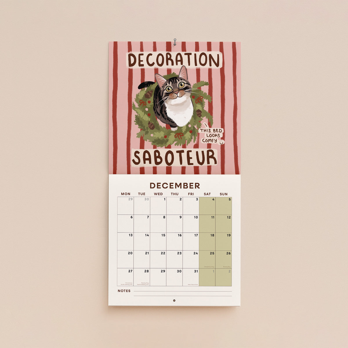 December page of cat-themed 2027 wall calendar with “Decoration Saboteur” and a cartoon cat