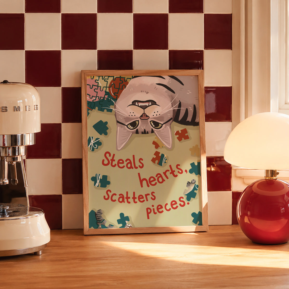Unframed cat puzzle print with cartoon cat, scattered puzzle pieces, and “Steals hearts, scatters pieces”