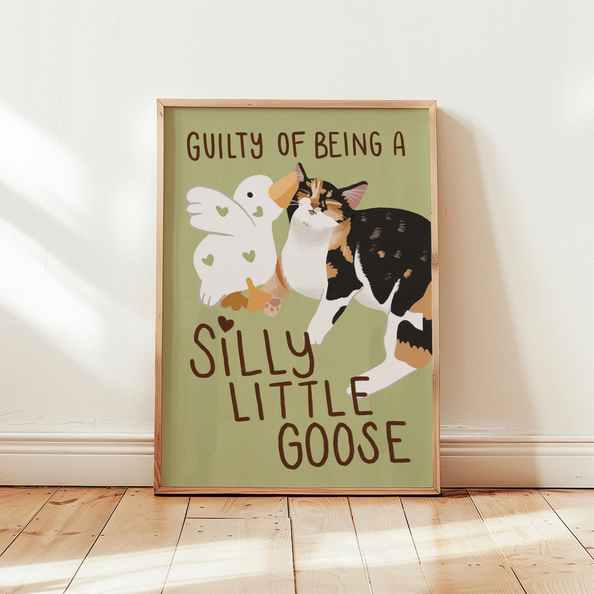 Unframed goose and cat illustration print with “Silly Little Goose” on pale green