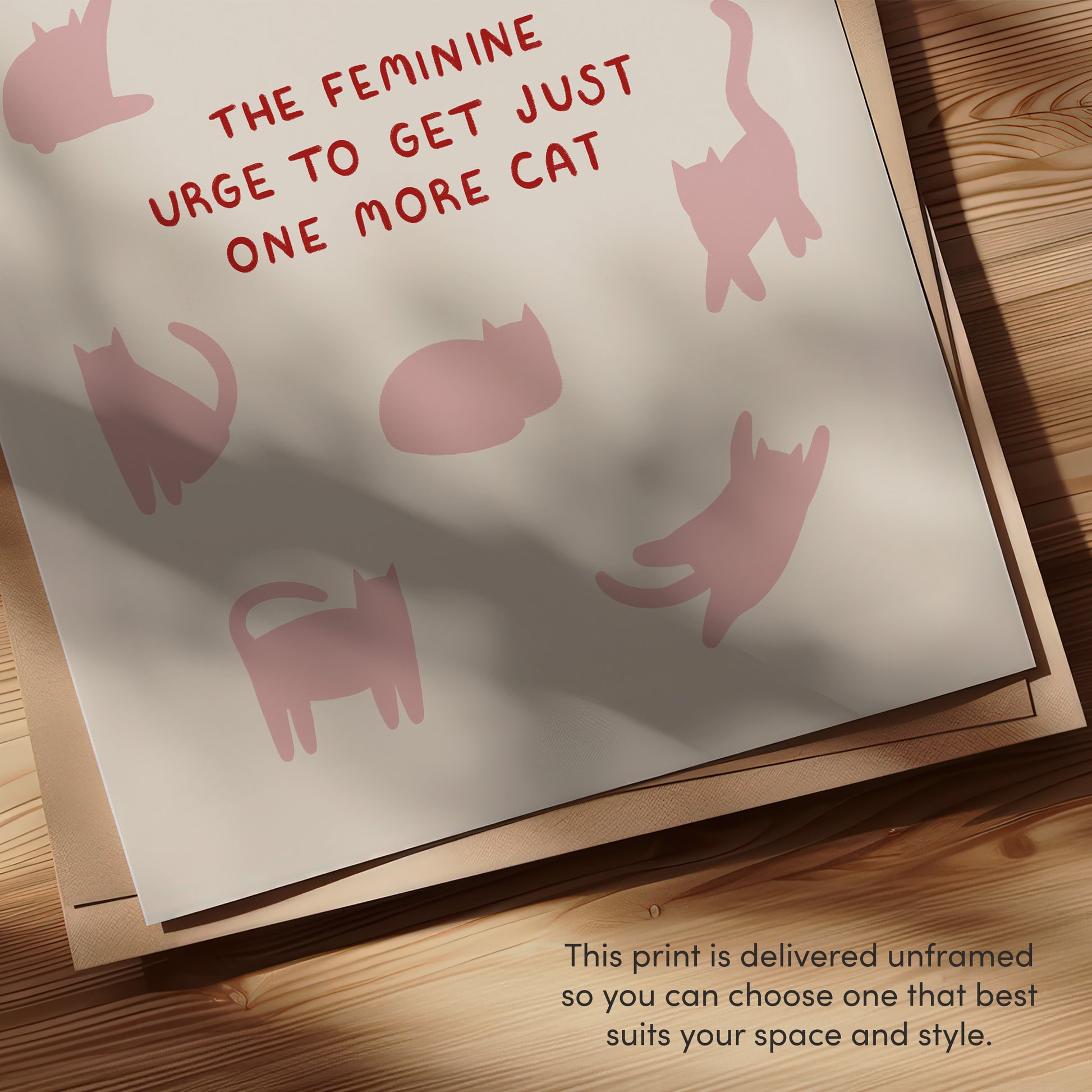 Close-up cat quote print: pink cat silhouettes with red “THE FEMININE…ONE MORE CAT”