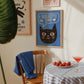 Unframed cat print wall art with black cat face and “I Believe in You” in white on blue background