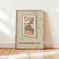 Framed cat spy print featuring window bars and 'NEIGHBOURHOOD SPY' text, green-themed accents.