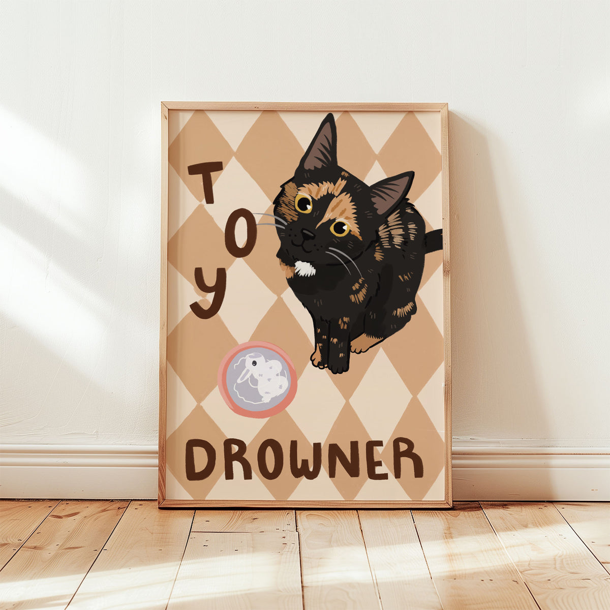 Cat print in tan-pink diamond pattern, black kitten with white muzzle, word 'DROWNER' visible