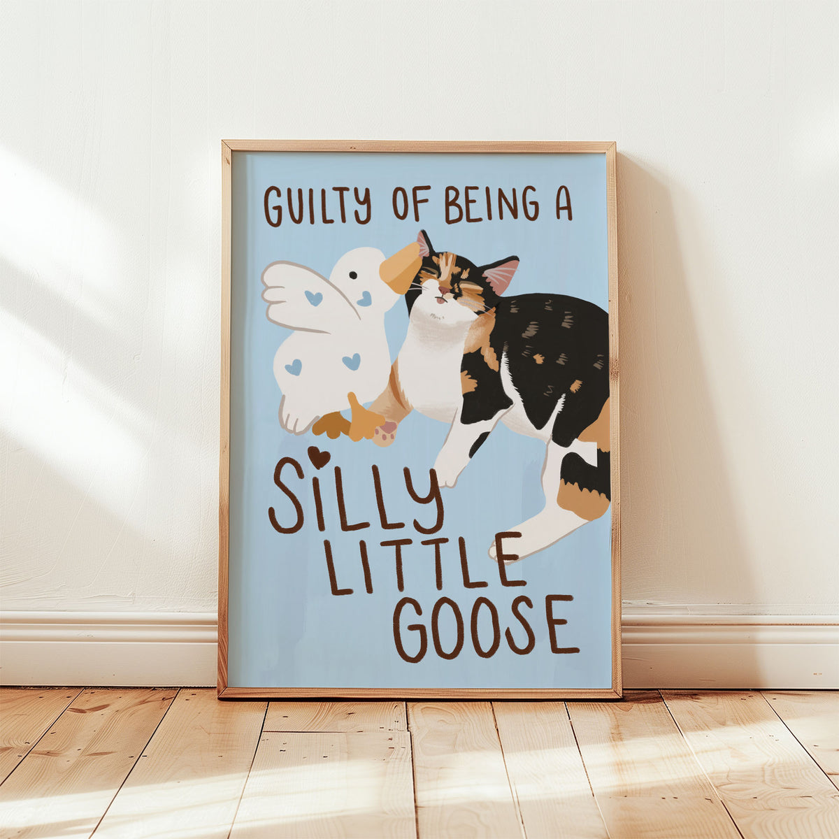 Unframed goose and cat illustration print with “Silly Little Goose” on light blue