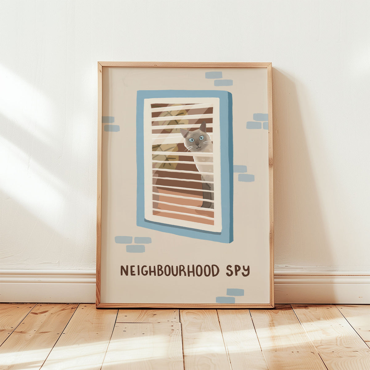 Framed cat spy print with window-bar illustration and 'NEIGHBOURHOOD SPY' text, blue accents.