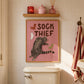 Framed cat print: 'SOCK THIEF' text with gray tabby cat and red, green, and white socks