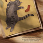 Cat print close-up: gray tabby, 'SOCK THIEF' text, colored socks on unframed paper