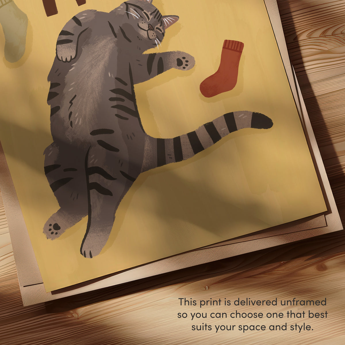 Cat print close-up: gray tabby, 'SOCK THIEF' text, colored socks on unframed paper