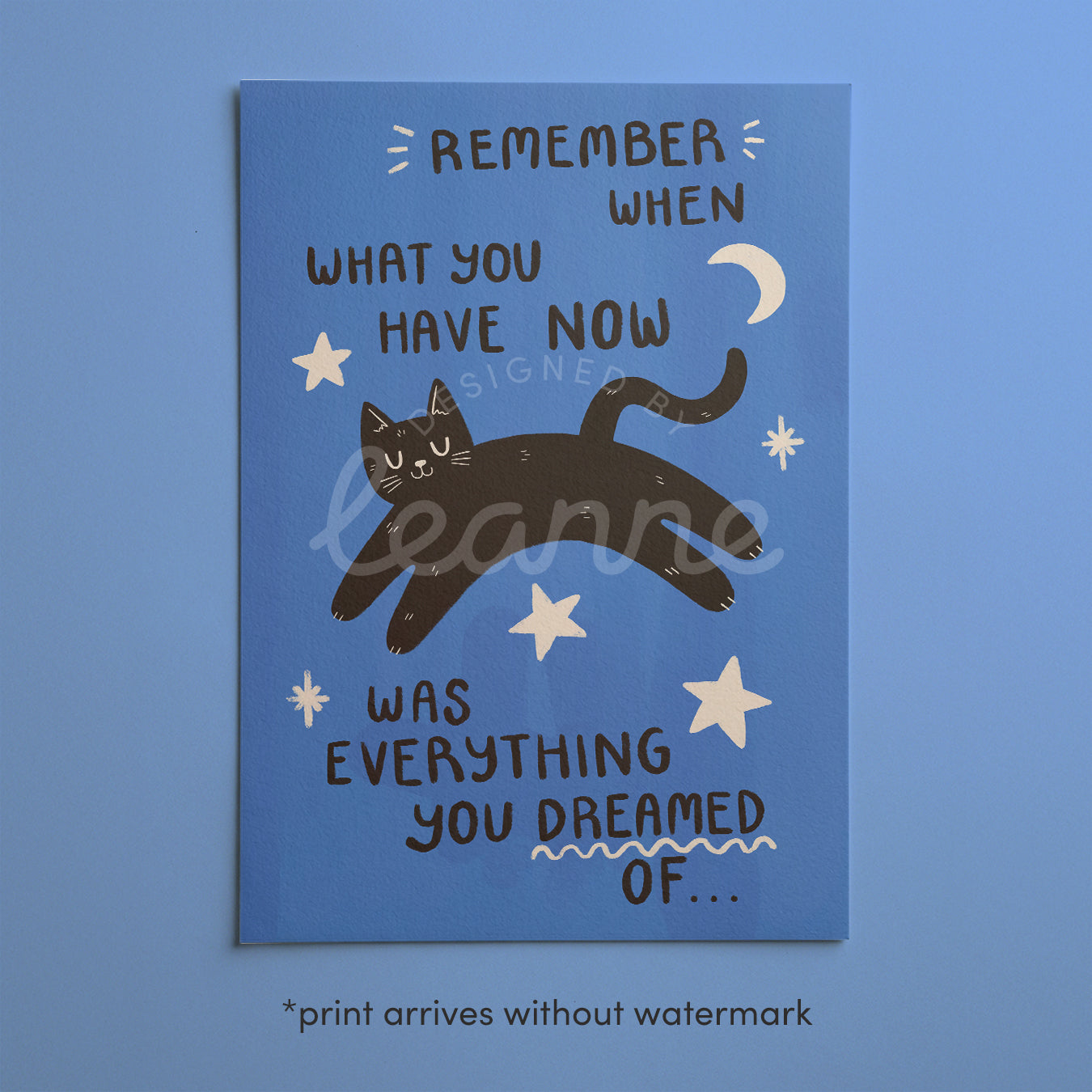 Close-up blue cat motivation wall print with black cat and handwritten quote text