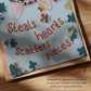 Close-up of unframed cat puzzle print border with “Steals hearts, scatters pieces” text