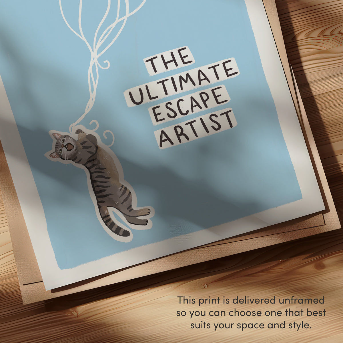 Close-up of cat wall art text "THE ULTIMATE ARTIST" with gray cat sticker illustration.