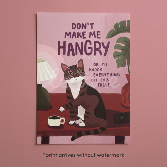 Cat art print in pink tones with green lettering “DON’T MAKE ME HANGRY” message