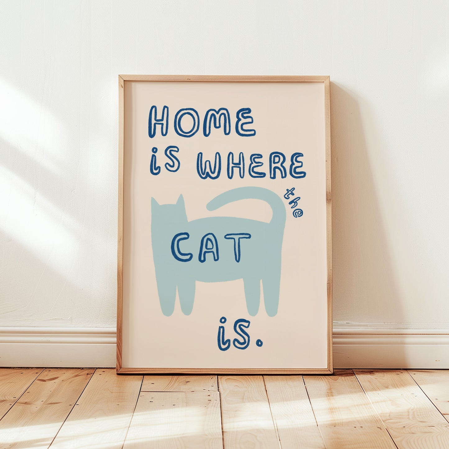 Home Is Where The Cat Is print: blue cat silhouette with blue “HOME” text, framed
