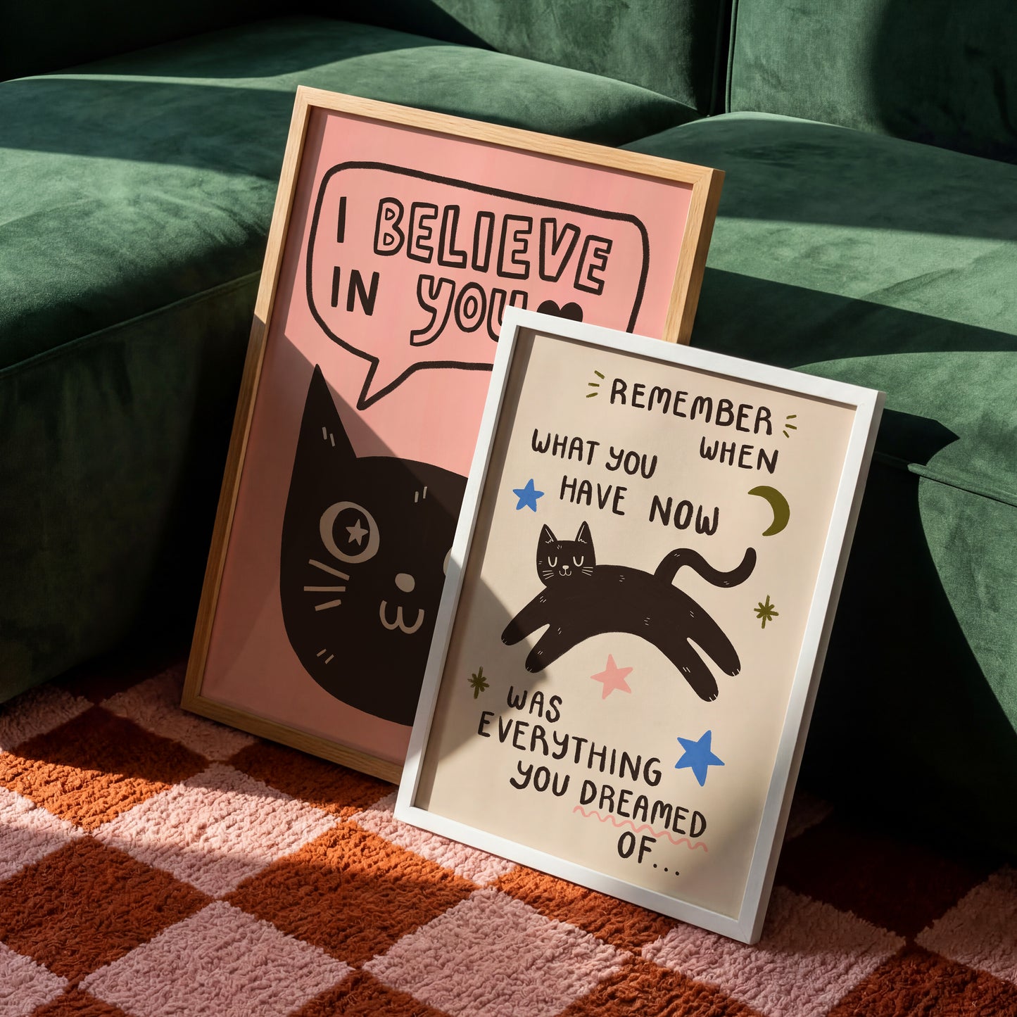 Two cat quote prints: pink “I Believe in You” cat and white “Remember what you dream” cat