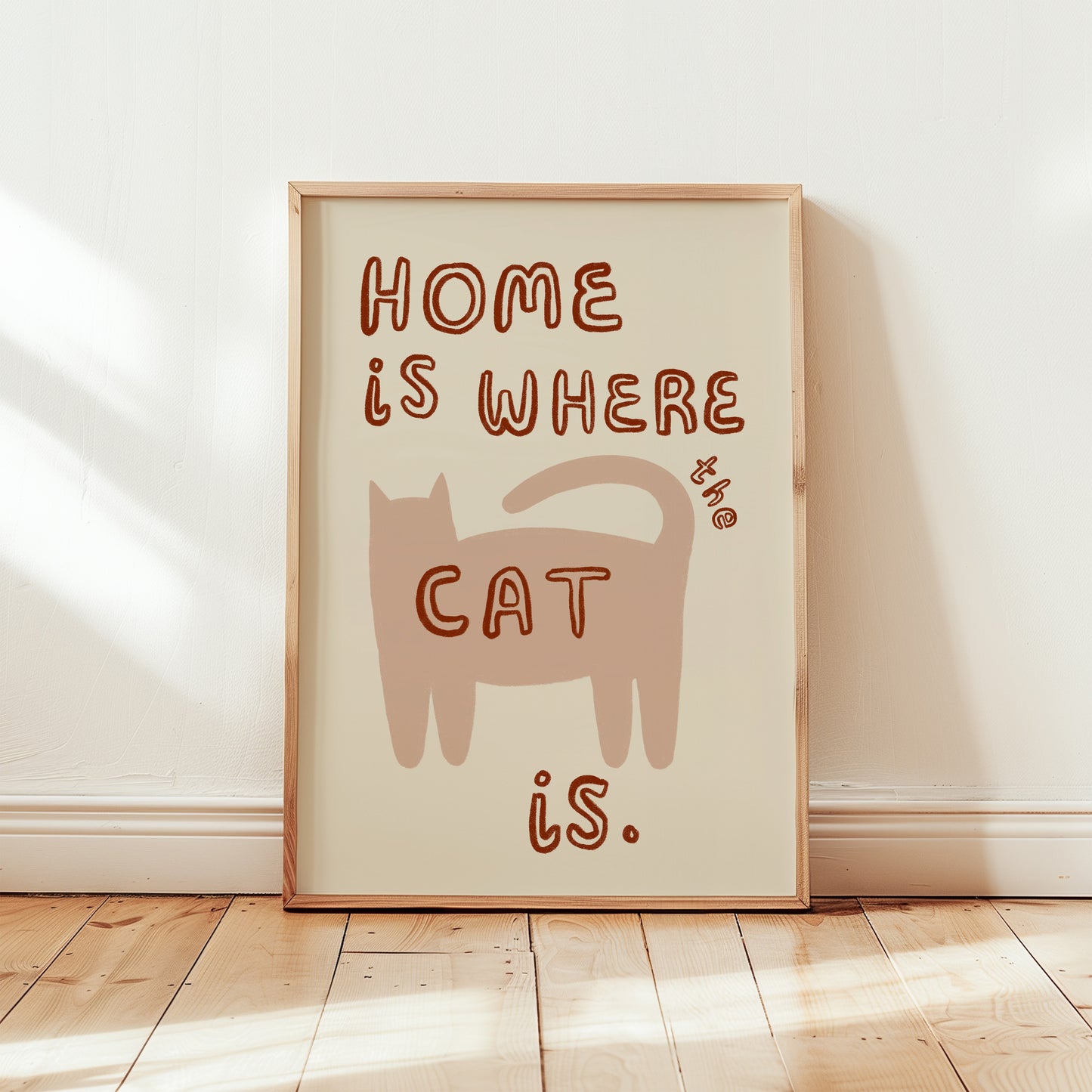 Home Is Where The Cat Is print: brown cat illustration with red-brown lettering, framed